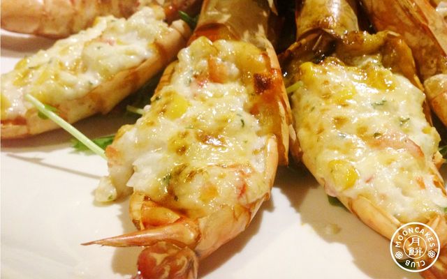 A plate of jumbo shrimp cut open with cream corn filling